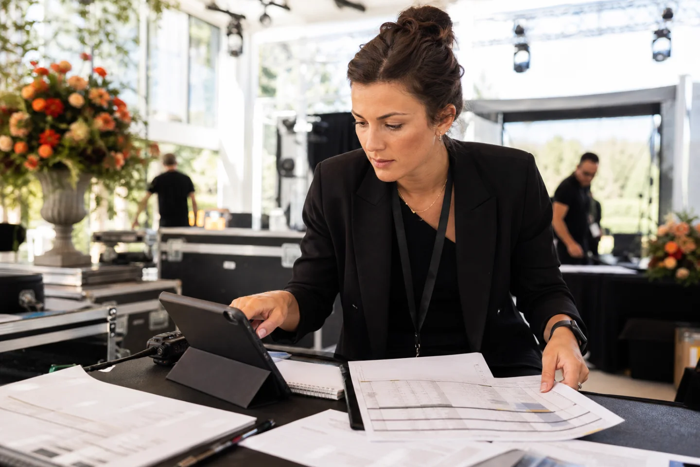 Event operations manager locating event details on a tablet during venue setup